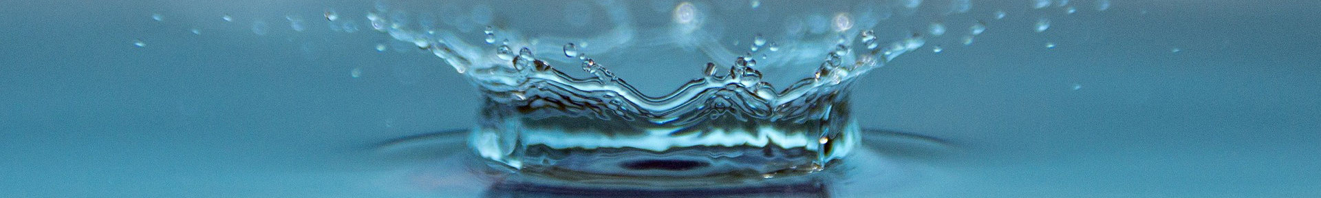 Water droplet splashing, causing ripples