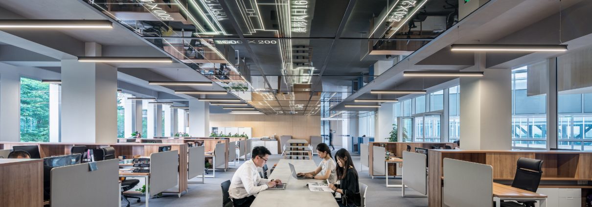 a man and woman sitting in an office space.