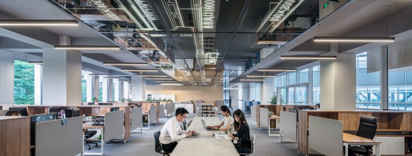 a man and woman sitting in an office space.